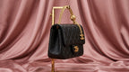 CHANEL Black Quilted Leather Mini Flap Bag with Gold Rosette Chain