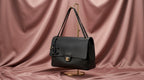 CHANEL Black Pebbled Leather Flap Bag with Gold Twist-Lock