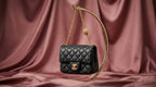 CHANEL Black Quilted Leather Mini Flap Bag with Gold Rosette Chain
