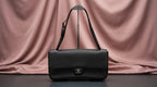 CHANEL Black Pebbled Leather Flap Bag with Turn-Lock Closure