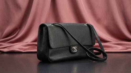 CHANEL Black Pebbled Leather Flap Bag with Turn-Lock Closure