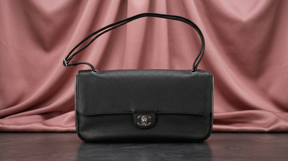 CHANEL Black Pebbled Leather Flap Bag with Turn-Lock Closure